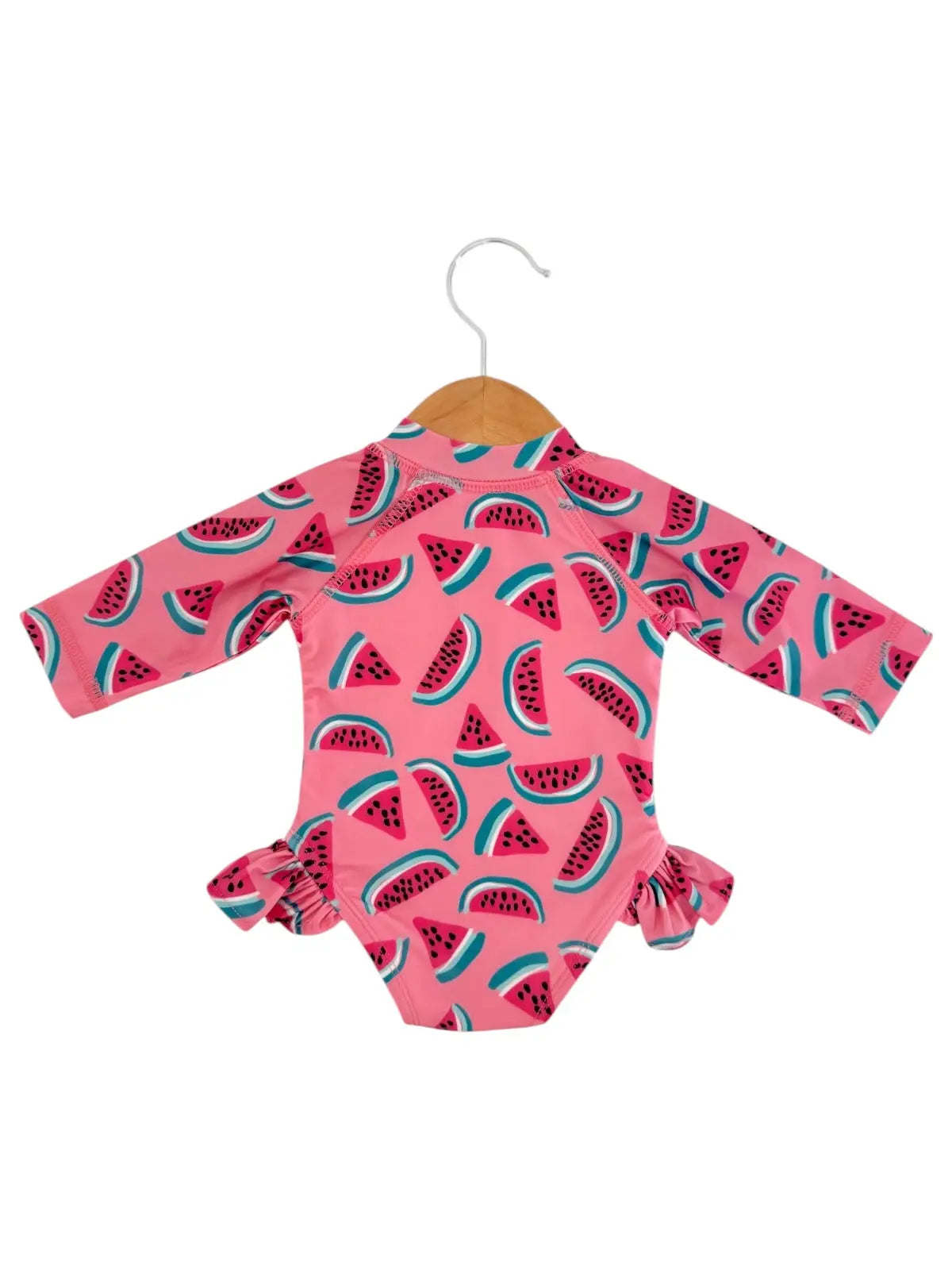 Pink baby onesie with watermelon pattern on a hanger against a white background