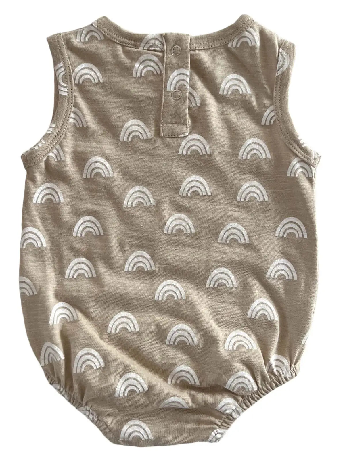 A beige baby bubble onesie with a rainbow pattern