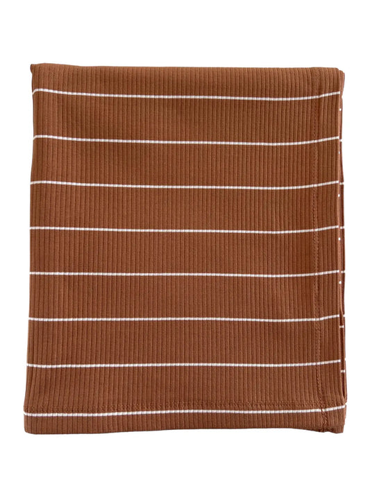 A brown swaddle blanket with white stripes, folded neatly.